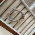 Detail of colorful plush scrunchie with multi-color knit texture in a wooden tray - Apricot