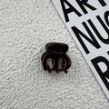 Detail view of handmade tortoiseshell hair claw clip with golden France logo print - Brown
