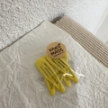 Detail view of yellow teardrop snap clips in transparent packaging with handmade sticker - Yellow
