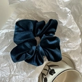 Detailed view of the dark blue luxury velvet hair scrunchie with soft pleated texture - Blue