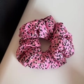Detailed view of pink leopard print satin scrunchie with soft ruffled fabric texture - Rose Red