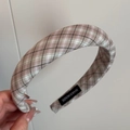 Detail of vintage brown and green tartan padded headband showing handmade label quality - Khaki Plaid