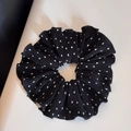Detail of a black and white polka dot scrunchie with soft ruffled fabric texture - Black-Large