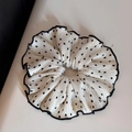 Macro detail of sweet pleated polka dot hair scrunchie with black wavy edge finish - White - L