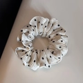 Detailed view of white polka dot scrunchie with pleated texture and soft fabric - White - S