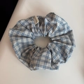 Close-up of blue and white plaid scrunchie with a Hand Made woven label on white background - Blue Series Scrunchie - Blue Gray Plaid