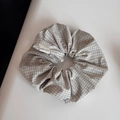 Detail view of the green and blue plaid scrunchie featuring a white Hand Made label - Scrunchie / Beige Mesh