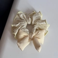 Close-up of cream polka dot scrunchie with large bow and delicate yellow edge stitching - Sweet Yellow - Padded Bow Tie