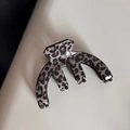 Macro shot of stylish leopard print hair claw clip with glossy finish and thick teeth - Gray Leopard Four Prong Claw