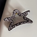 Macro detail of star-shaped hair claw clip with stylish black and grey leopard print pattern - Gray Leopard Star Shape Claw