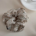 Detail of floral scrunchie with semi-transparent fabric and black fashion label - Beige Floral Pastoral Scrunchie