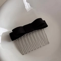 Detail of multi-layered black fabric bow hair comb with thirteen silver metal prongs - Black