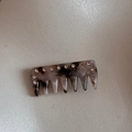 Macro detail of tortoise shell hair comb featuring shimmering crystal rhinestones inlay - Tortoiseshell (FJ89930)