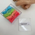 Cinque elastici per capelli ad alta elasticità in colori vivaci con scatola trasparente - Fiocco Colorato