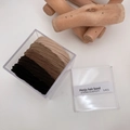 Detailed view of high elasticity hair bands in earth tones inside a clear plastic storage box - Twill Weave