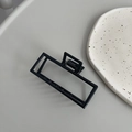 Detail view of a minimalist black square metal hair claw clip with a glossy finish - Square Large (7cm) / Black