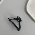 Detail shot of the black matte metal claw clip featuring a minimalist hollow geometric design - Hanger Semicircle (4.5cm) / Black