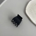 Minimalist black square hair claw clip with glossy finish on a grey aesthetic background - Right Angle Black