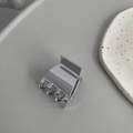 Close-up of a small polished silver metal hair claw clip with a secure spring design - Squared Silver