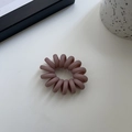 Close-up of matte spiral hair tie in dusty rose pink on a minimalist white surface - Pink