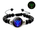 Detail of glow in the dark Taurus zodiac charm on black matte beaded adjustable bracelet - Taurus