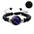 Detailed view of black beaded Sagittarius zodiac bracelet with luminous glowing effect - Sagittarius