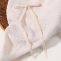 Elegant cream velvet bow hair clip with long streamers on a white mesh texture - Off White