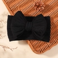Elastic baby headband in black featuring a large bow and ribbed jacquard fabric - Black