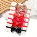 Set of 6 elastic baby bow headbands in assorted solid colors on a display card - Style C (Code)