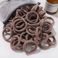 Brown high-elasticity nylon hair ties spilling from a frosted zipper bag on a white background - 20 Pieces Set / Brown (48)