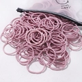 Light purple high elasticity hair ties set spilling from a matte frosted zipper bag - 50 Pieces / Lotus root pink