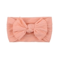 Detailed macro shot of soft nylon baby headband with textured knit bow in coral pink - Coral Pink (15)