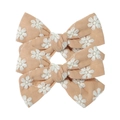 Detailed view of three light orange fabric hair clips with embroidered daisy patterns - Pale Orange with White Daisy Embroidery
