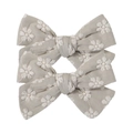 Detail shot of two grey fabric bow hair clips with delicate white daisy embroidery - Light Gray with White Daisy Embroidery