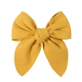 Detail view of ginger yellow woolen bow hair clip with textured fabric on white background - Ginger Yellow (10)