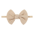 Detail of a beige cotton infant bow headband with textured weave and elastic nylon band - Light Apricot (32)