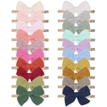 Detailed view of twenty colorful baby bow headbands with elastic nylon straps and numbered tags - Multicolor Mixed