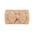 Close-up of beige knitted baby headband with a large bow and cable knit texture - Light Coffee