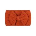 Close-up of cable-knit texture and large bow on rust orange elastic baby headband - Burnt Orange