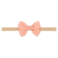Detail view of handmade baby bow headband with high elastic nylon ribbon in apricot color - Light Orange