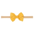 Detailed view of handmade ginger yellow ribbed ribbon bow on soft nylon baby headband - Turmeric