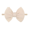 Close-up of beige elastic knit baby headband featuring a soft ribbed texture bow - Beige