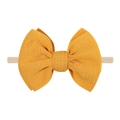 Close-up of yellow textured fabric bow and high-elastic nylon headband for infants - Yellow