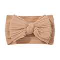 Soft beige cable knit baby headband with a large decorative bow and stretchy nylon band - Beige