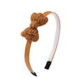 Close-up of caramel brown crochet bow headband with ribbed ribbon and protective fabric ends - Caramel Brown
