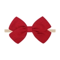 Detail shot of a red linen-textured bow on a soft beige elastic baby headband - Bright Red Bow (16)