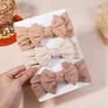 Three-pack elastic baby headbands with jacquard bows in cream, tan, and dusty pink - 3D (Without Cardboard)