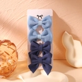 Set of four blue fabric bow hair clips for girls displayed on a white branded card - Blue Series Fabric Style (5)