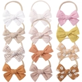 Set of 12 nylon baby headbands with large bows in various colors and floral patterns - Mixed Styles