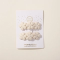 Set of two cream-colored fabric flower hair clips on a white presentation card - Three Small Flowers Style (2A-5) / Cream